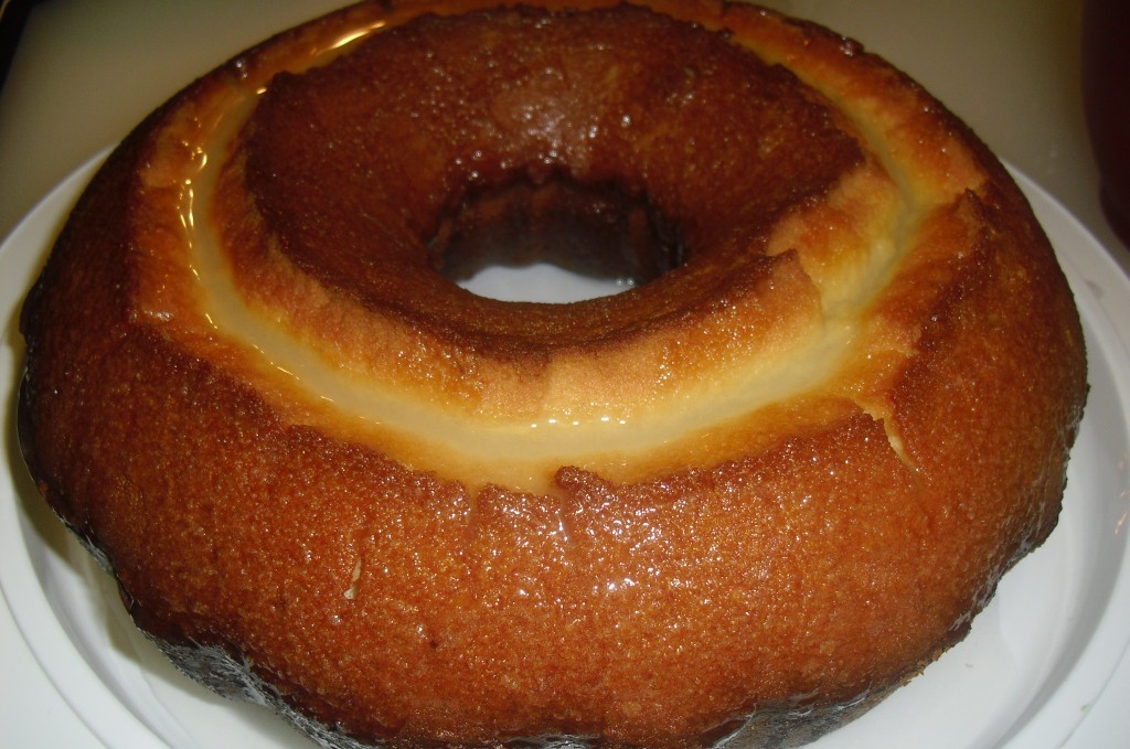 Golden and moist 7Up Cake coated in a sweet glaze and served on a round white platter. 