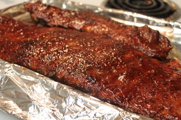 These crockpot barbecue ribs are the perfect way to get deliciously cooked ribs without a grill. Check out this super simple recipe!