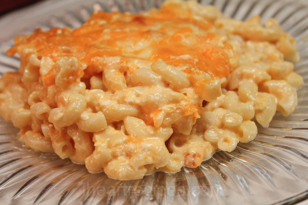 a square of southern baked macaroni and cheese on a glass plate.