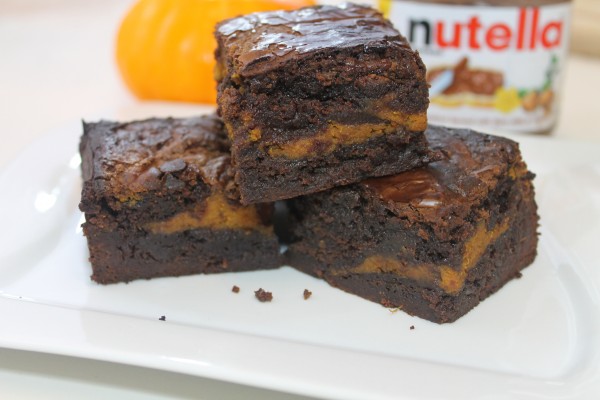 A stack of Nutella Pumpkin Fudge Brownies showcasing layers of gooey sweetness.