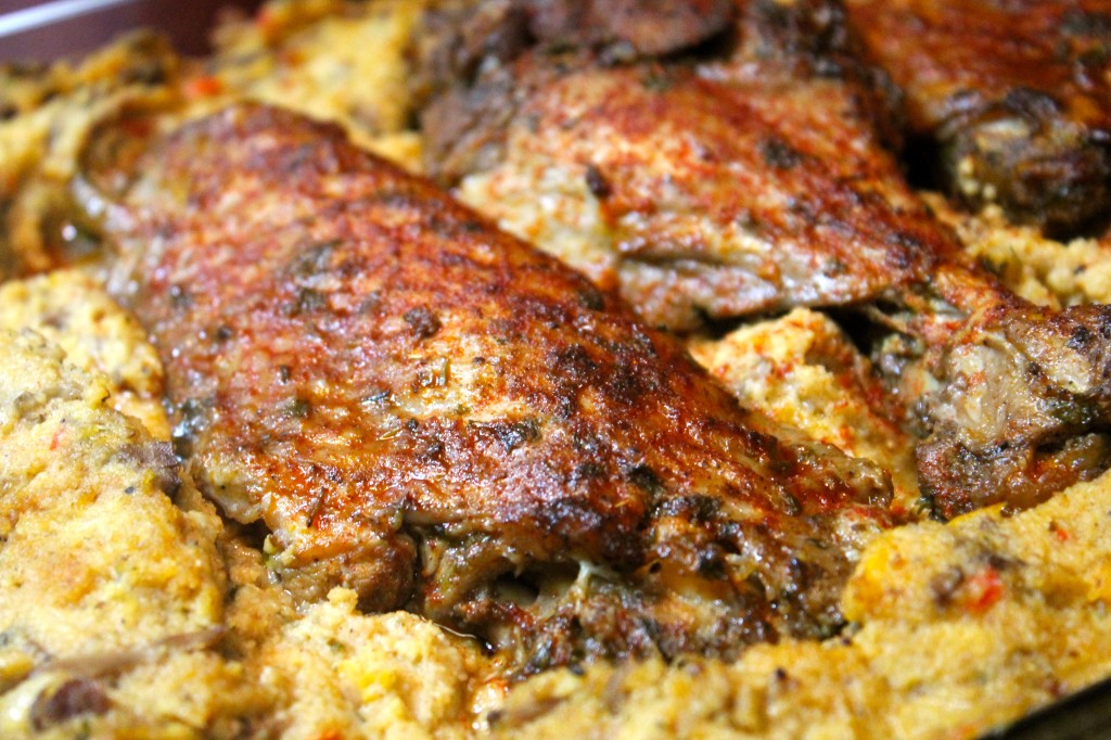 Golden-brown baked turkey wings served atop a homemade cornbread dressing.
