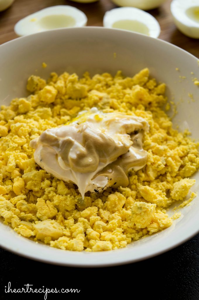 Crumbled egg yolks, dijon mustard and mayo in a mixing bowl. 