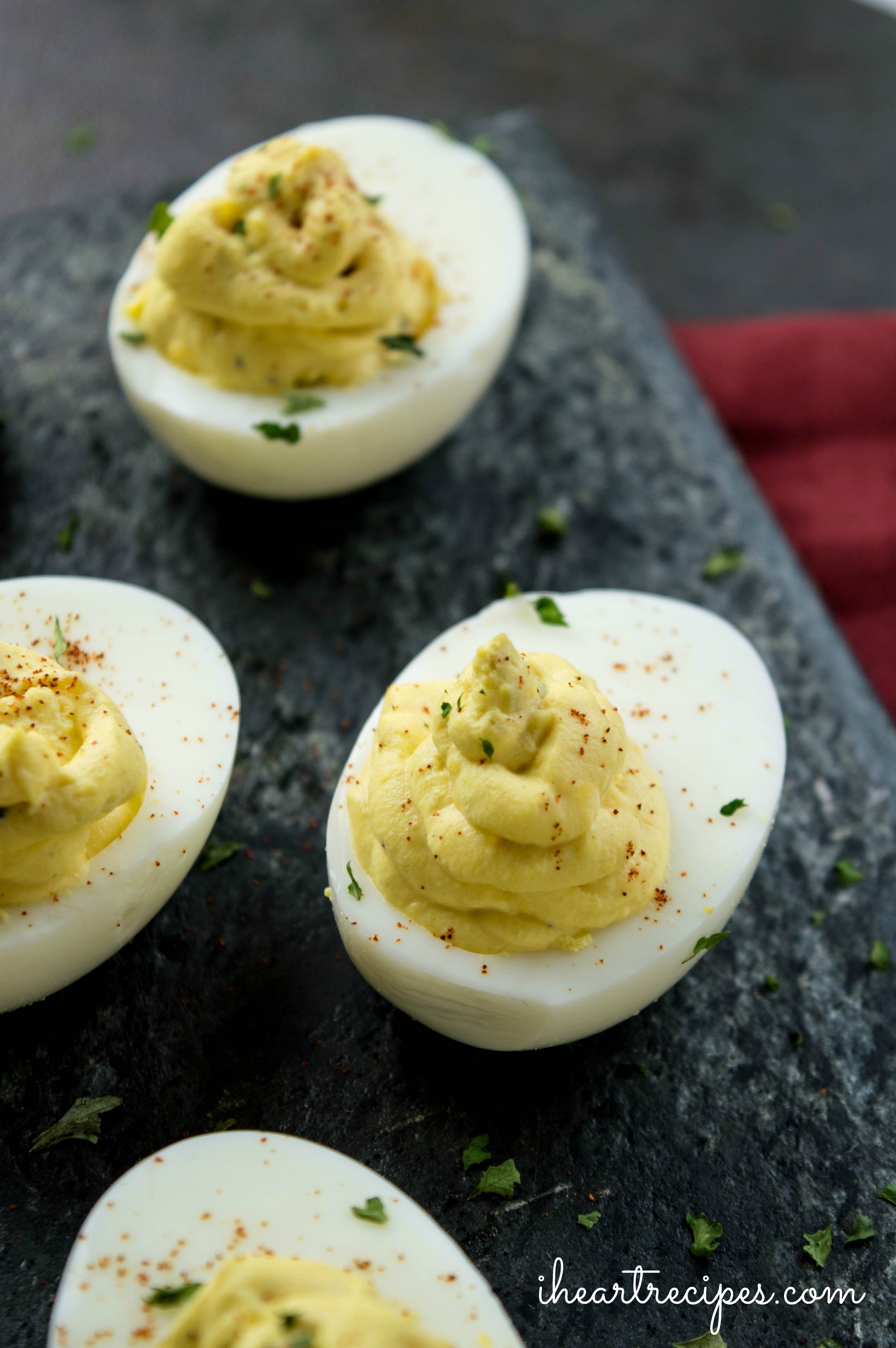 Garnish the deviled eggs with paprika and chopped parsley to make them party ready.