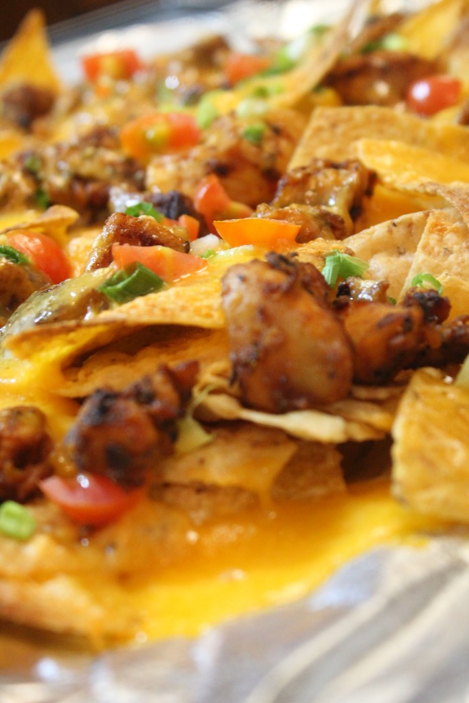 Seasoned grilled chicken, melted cheese and delicious veggies top these game-day nachos.