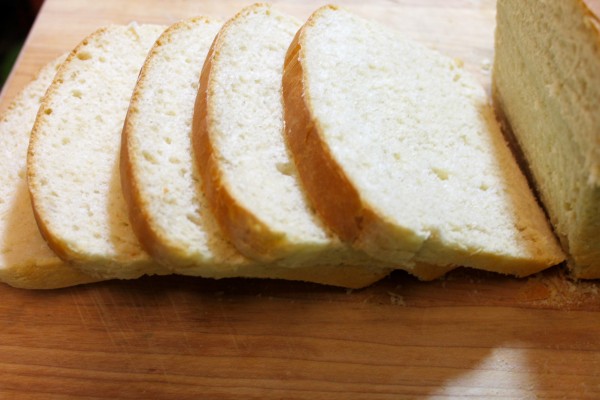 Slices of moist and fluffy homemade white bread on a cutting board. This homemade white bread recipe only needs a few ingredients and is beginner-friendly.