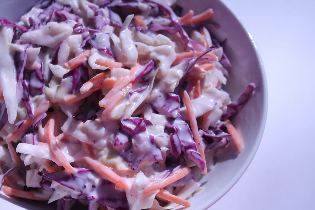 A bowl full of creamy Miracle Whip coleslaw, made with shredded cabbage, carrots, and a tangy dressing.