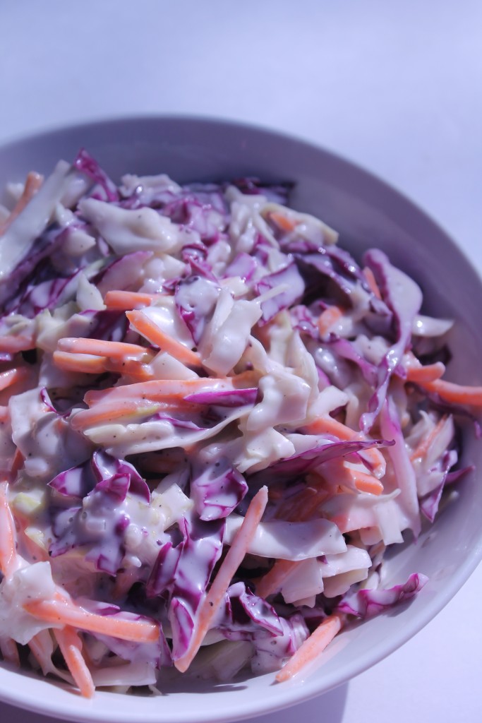 A bowl of homemade creamy coleslaw with chopped cabbage, chopped carrots, and a sweet and tangy Miracle Whip-based dressing.