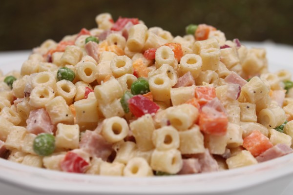 A creamy pasta salad with ham, cheese and peas.