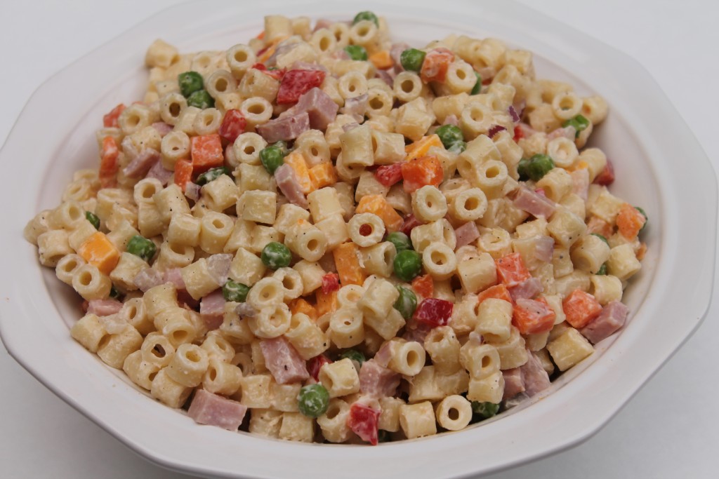 Creamy summer pasta salad in a white bowl. Combine cooked macaroni pasta, colorful fresh vegetables, and a creamy mayo-based dressing to make this easy pasta salad.