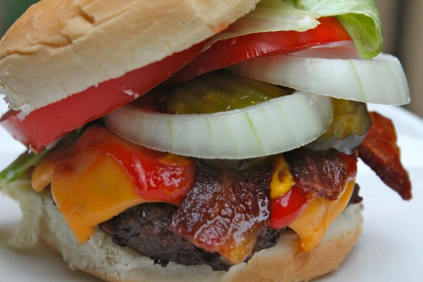 This is one deluxe bacon cheeseburger with onions, tomatoes, lettuce, cheddar cheese, and tender bacon