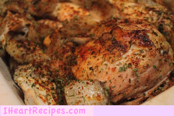 A close-up image of golden seasoned whole chicken in the crockpot.