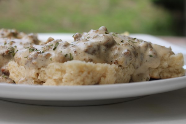 Homemade buttermilk biscuits covered with creamy sausage gravy