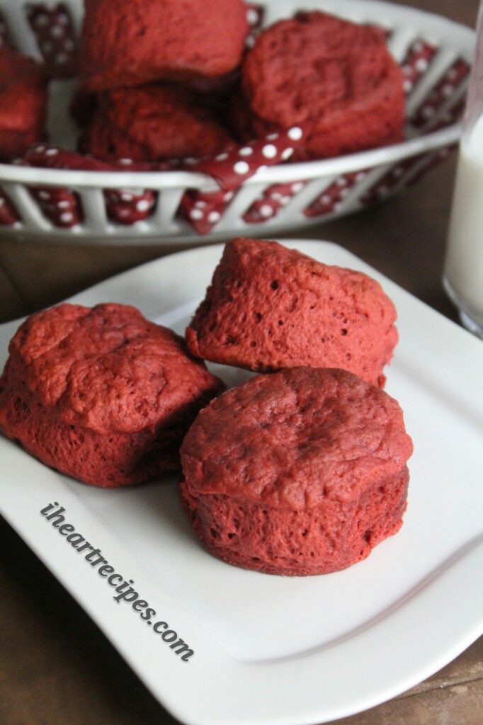 Three light and flaky Red Velvet Biscuits stacked on a white plate. 