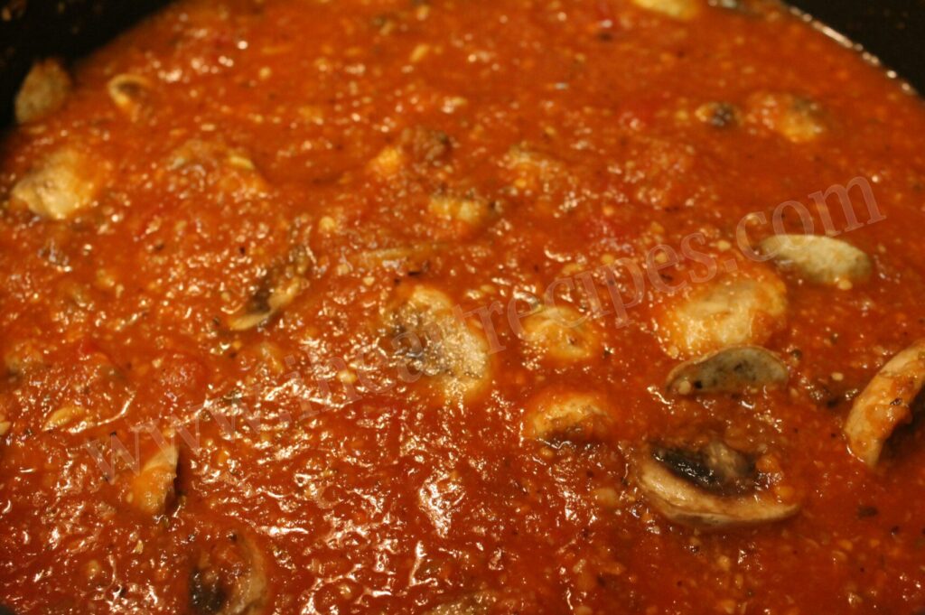 Veggies simmering in a homemade red sauce. This sauce adds depth to chicken parmesan casserole.