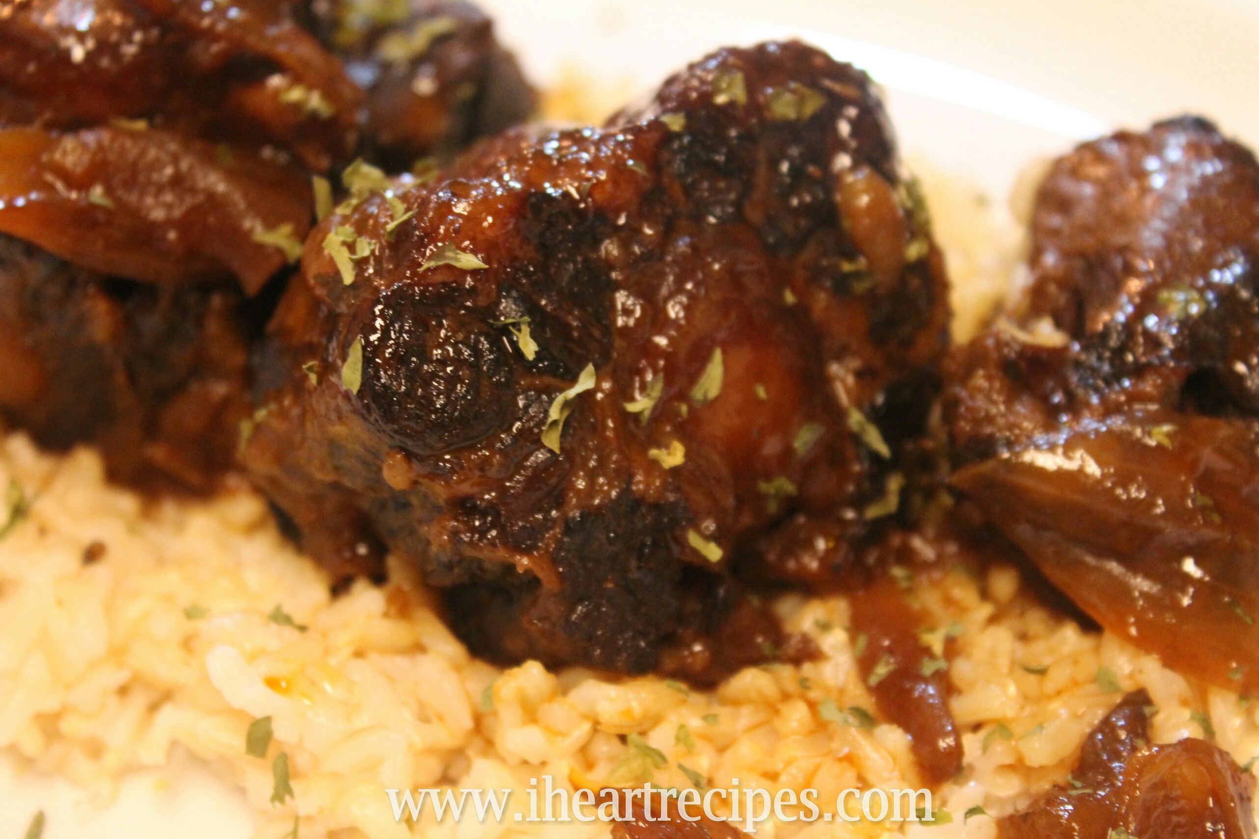 Tender slow cooked BBQ oxtails served over seasoned white rice