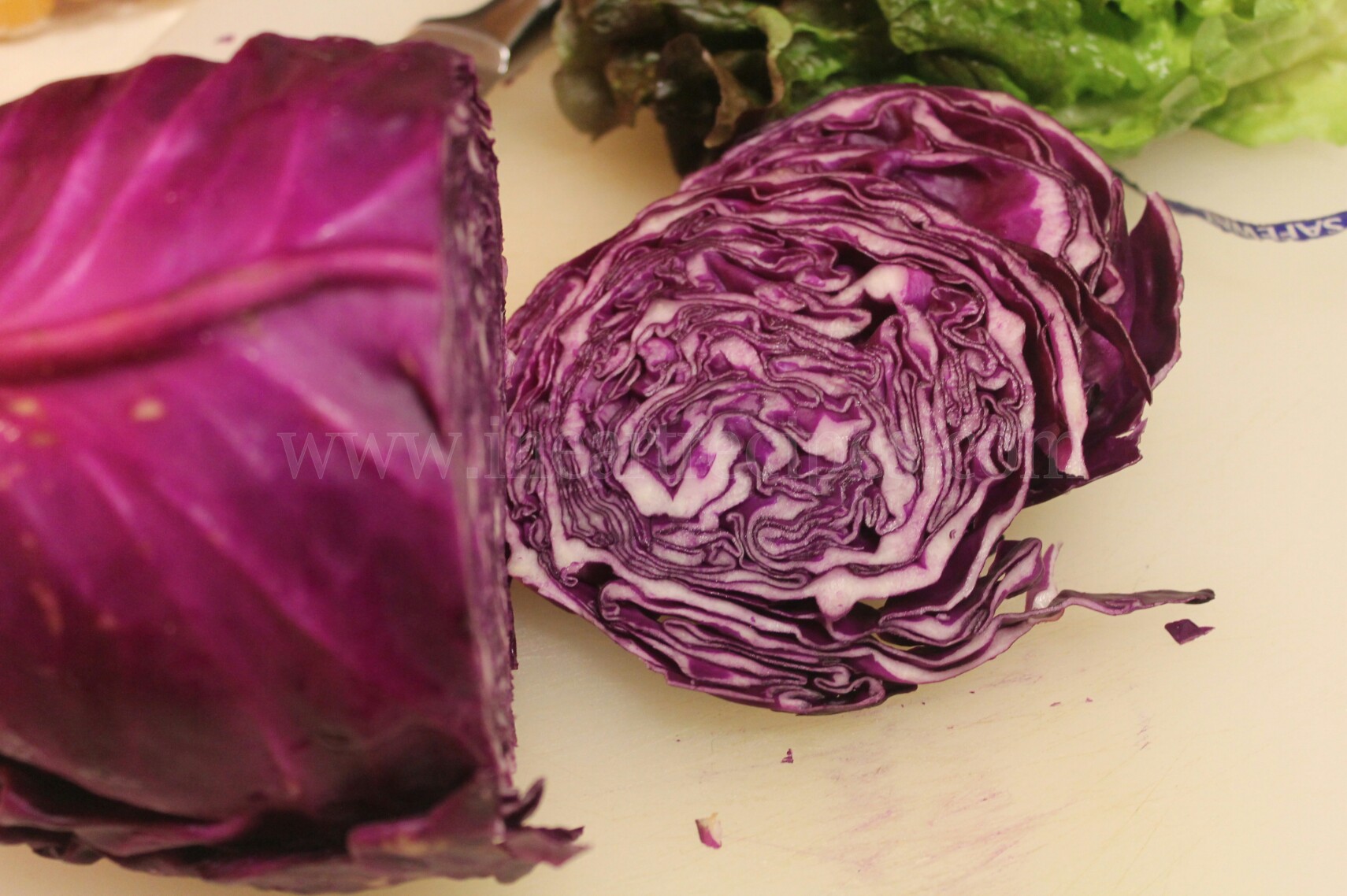 A head of red cabbage sliced into shreds. It gives this Bacon and Goat Cheese Spring Salad a nice crunch.