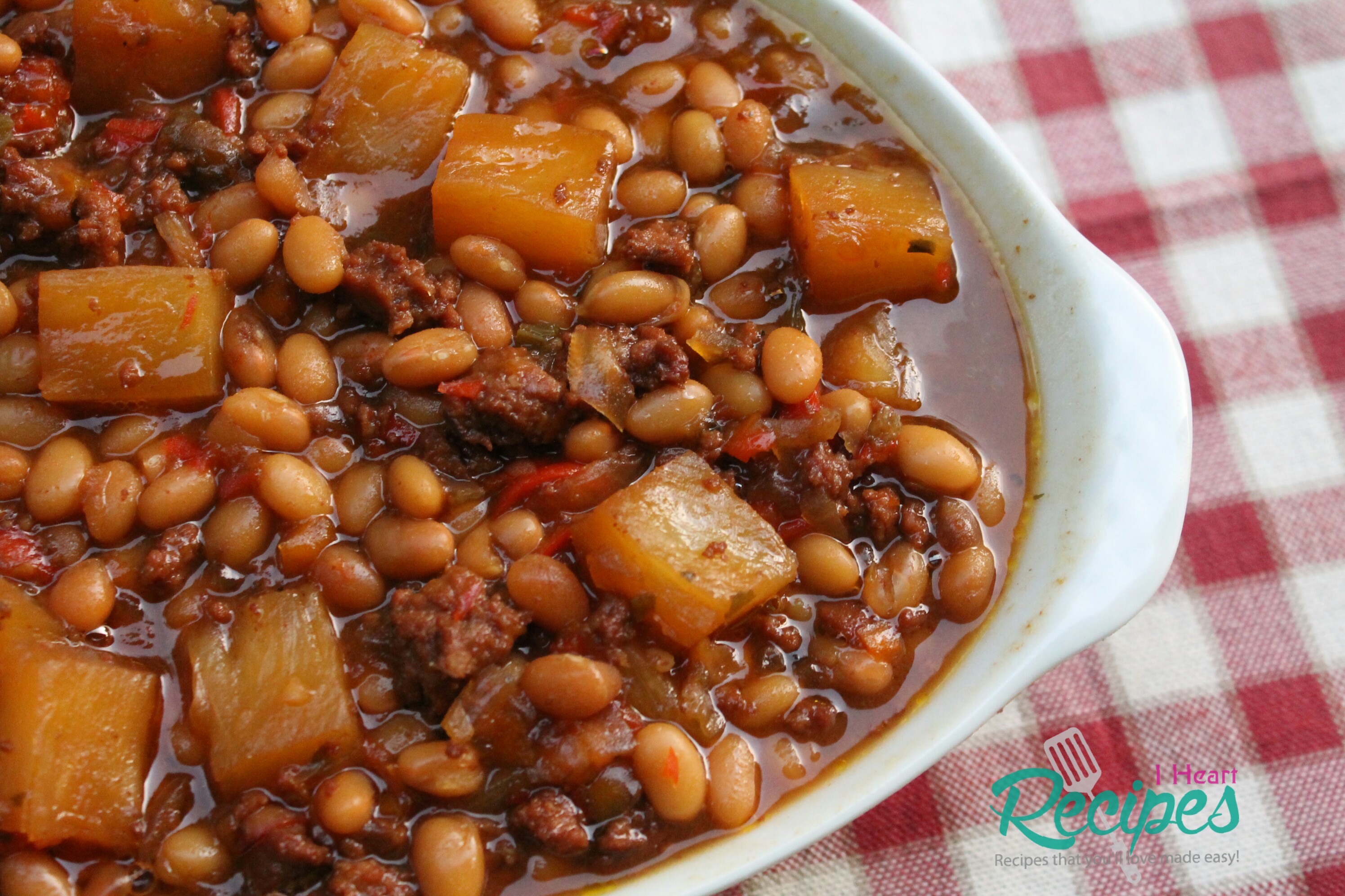 sweet and savory baked beans in a brown sugar sauce with pineapple chunks and bacon