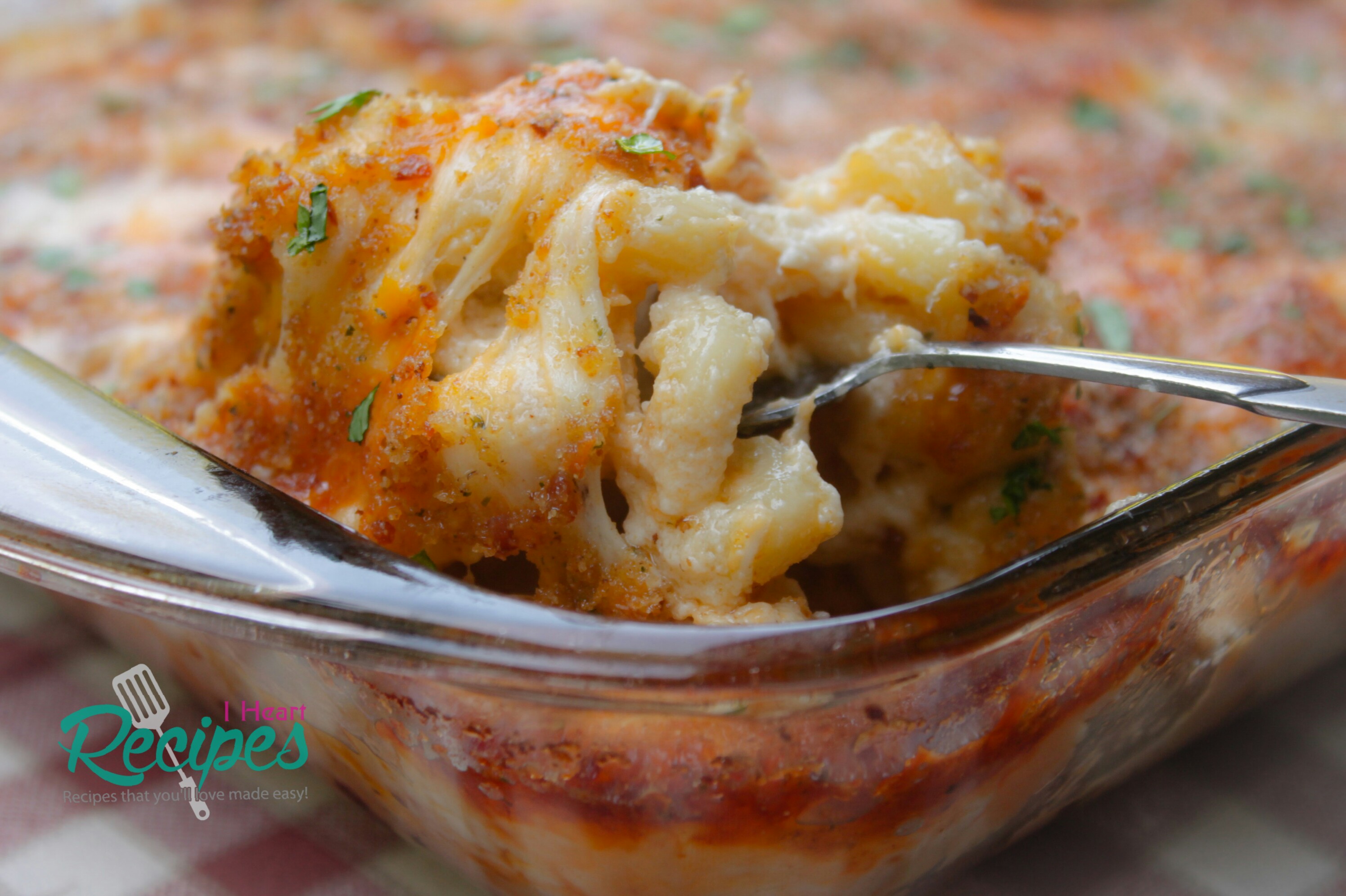 A generous spoonful of creamy, cheesy lobster mac and cheese, homemade with cavatappi noodles, a rich cheese sauce, and buttery bacon breadcrumbs.