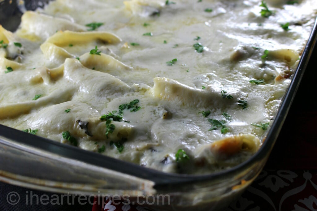 Creamy turkey and collard greens stuffed shells in a casserole dish. A unique recipe to add to your usual holiday dishes. 