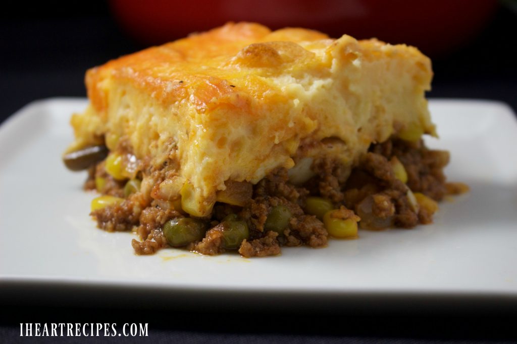 A slice of savory Deluxe Shepherds Pie served on a classic white plate. 