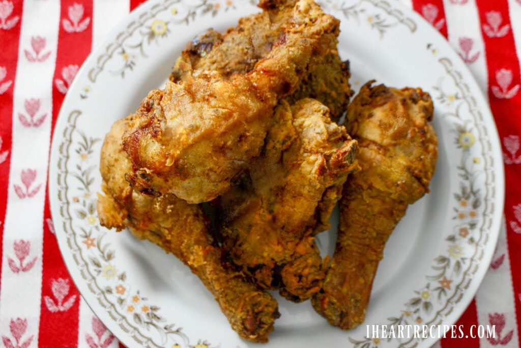 Crispy and tender southern fried chicken served on a floral plate.