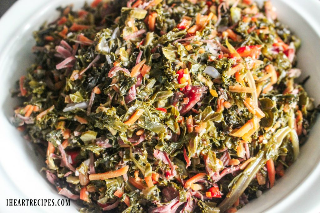Tender Braised Southern Style Kale served in a white serving dish. This is a delicious and healthy side dish that's easy to whip together.
