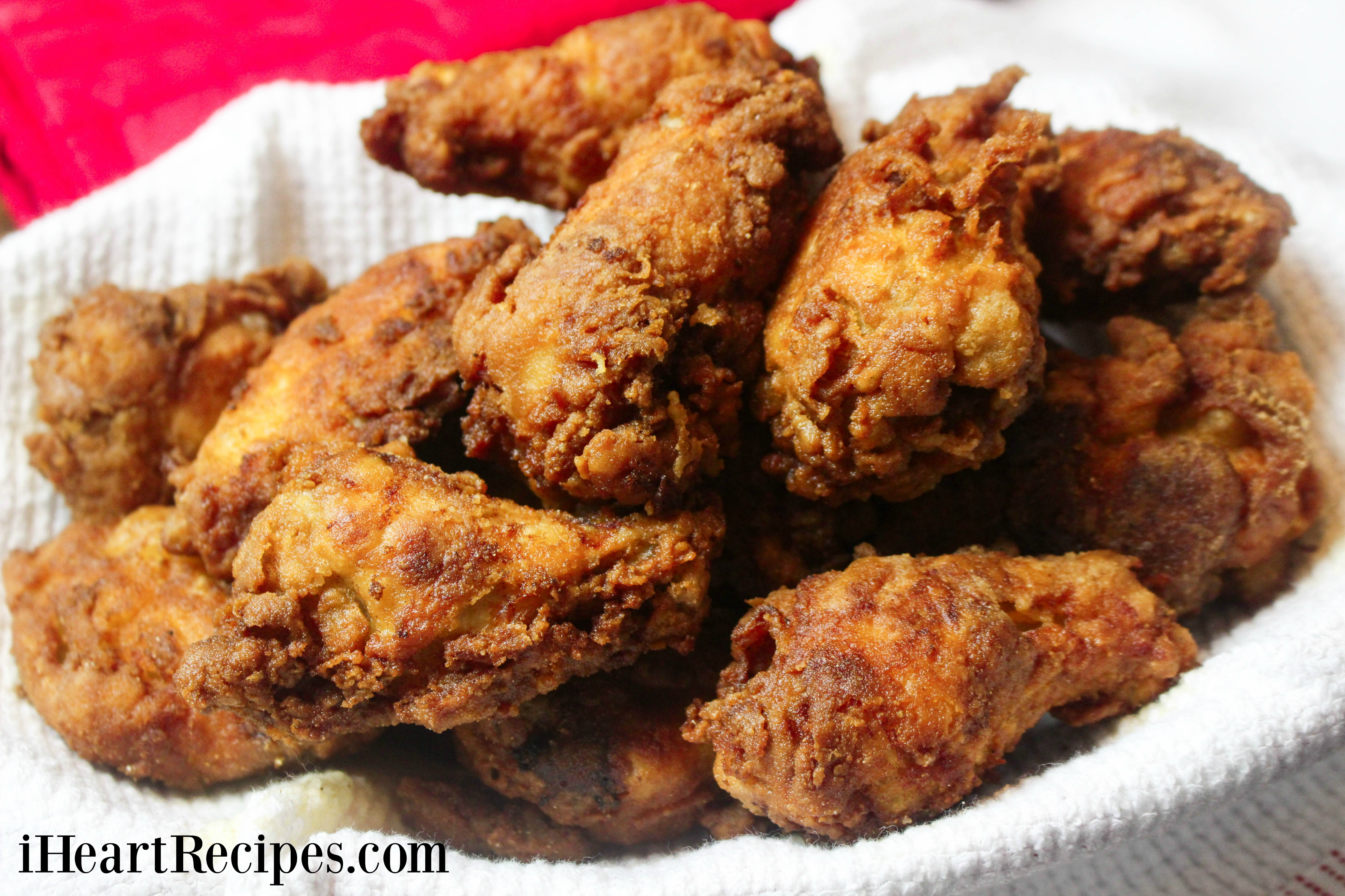 Crunchy waffle batter fried chicken served on a towel-lined platter. This recipe is amazing and delicious!
