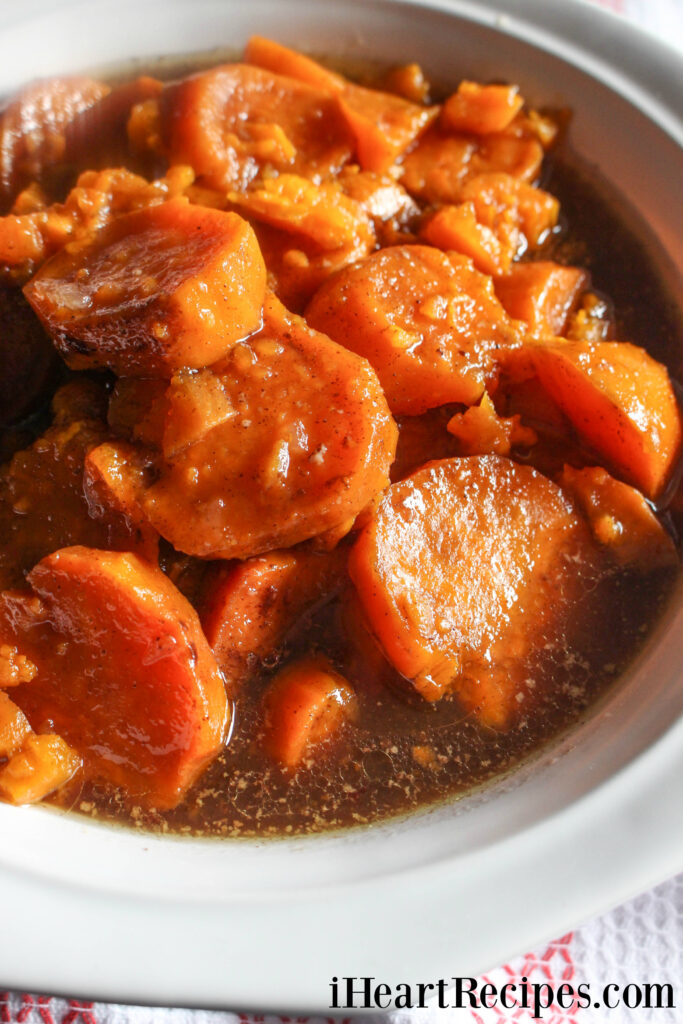 Buttery and velvety yams simmering in a white slow cooker. They