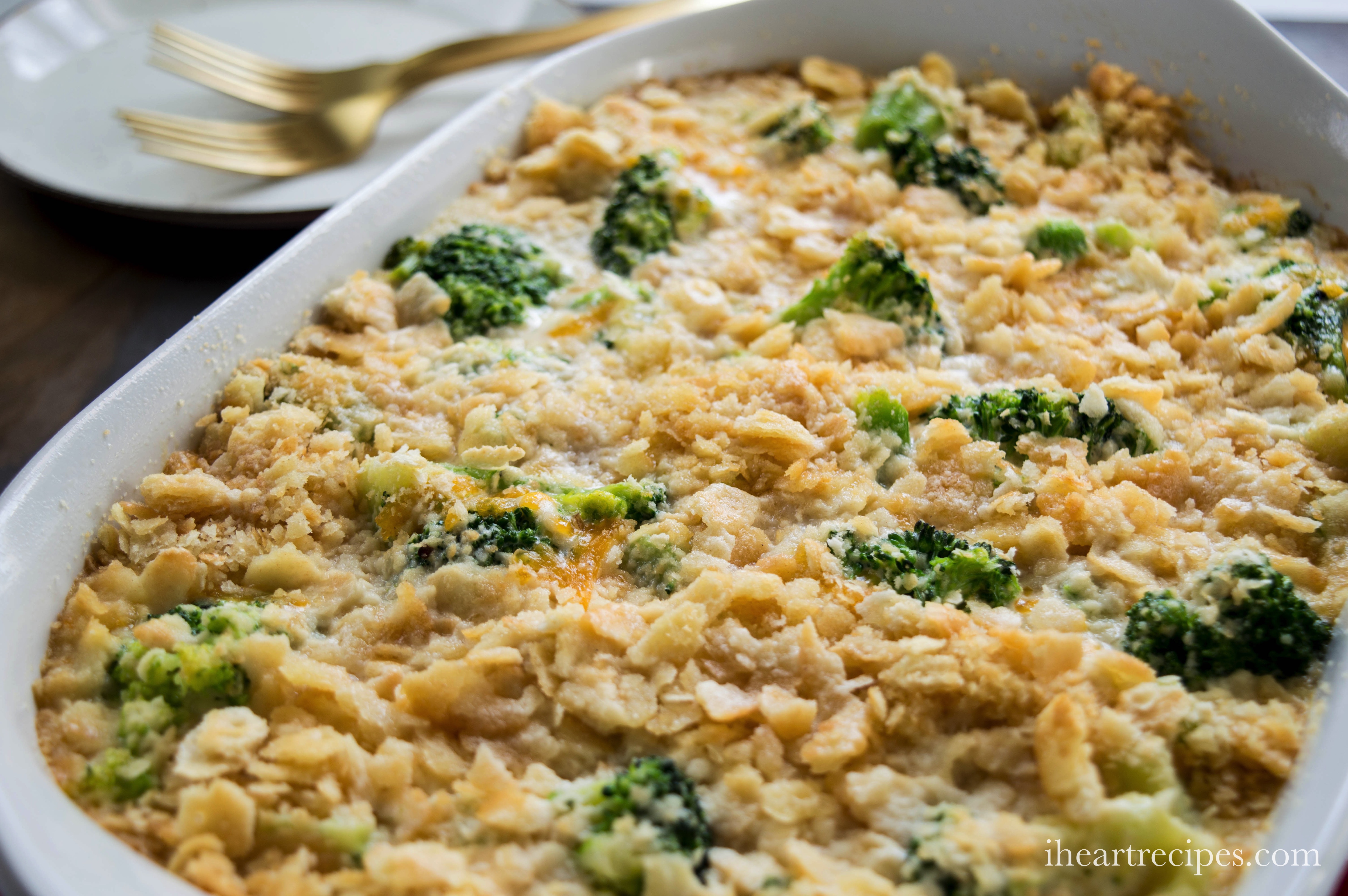 Creamy southern broccoli casserole topped with a crunchy layer served in a white serving dish. The perfect comfort food!
