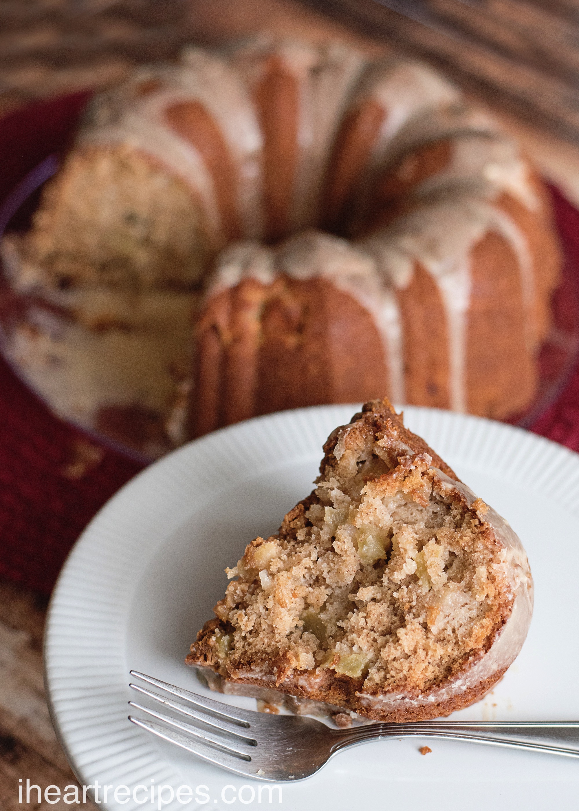 Delicious fresh apple cake with a simple maple glaze served on a white plate. This is the dessert your guests have been waiting for!