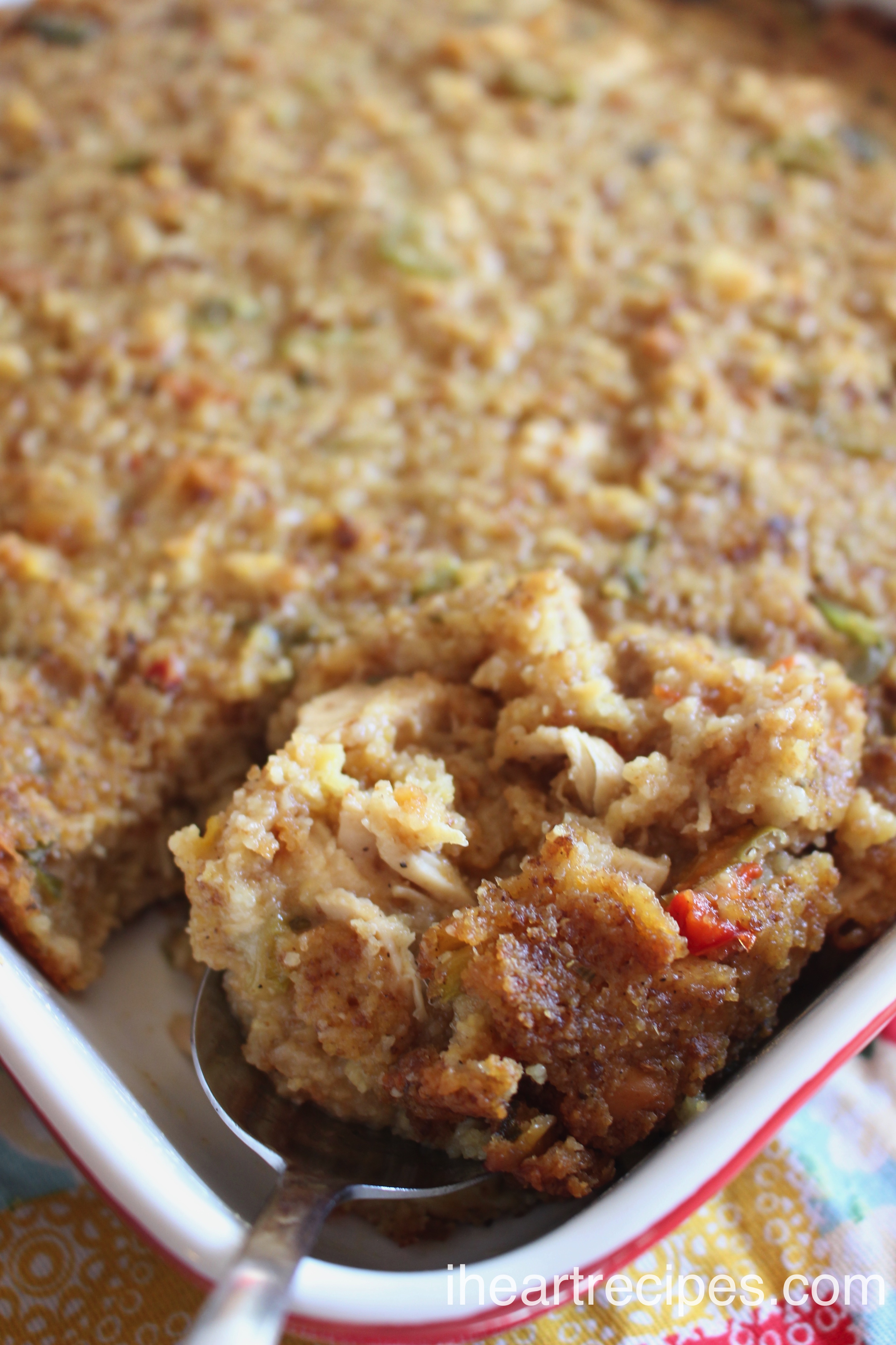 A spoonful of Southern Cornbread Dressing ready to be served. This dish is packed full of savory flavor!