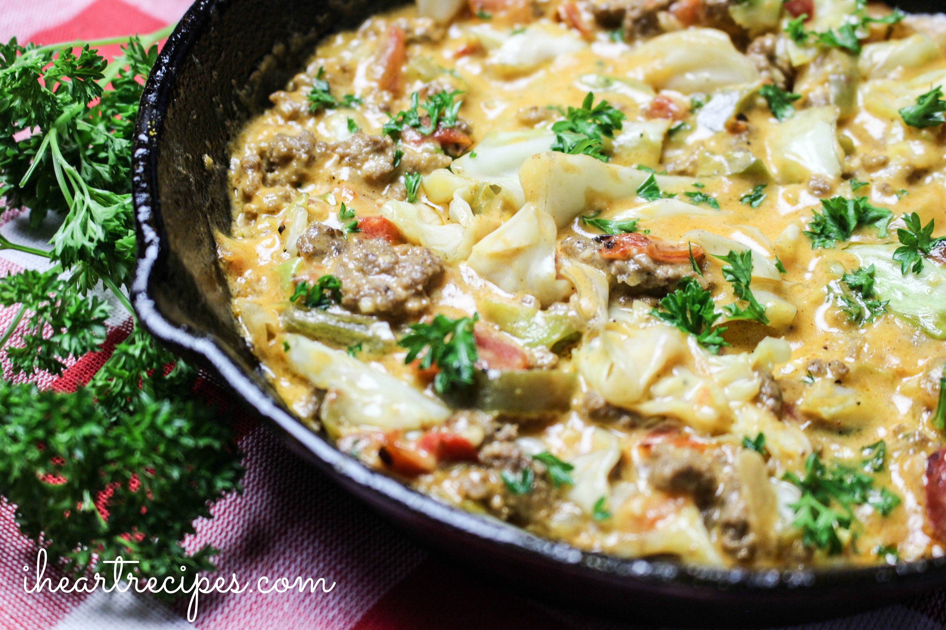 Creamy Cheesy Cabbage Creole simmering in a cast iron skillet. This dish is a kaleidoscope of flavors!