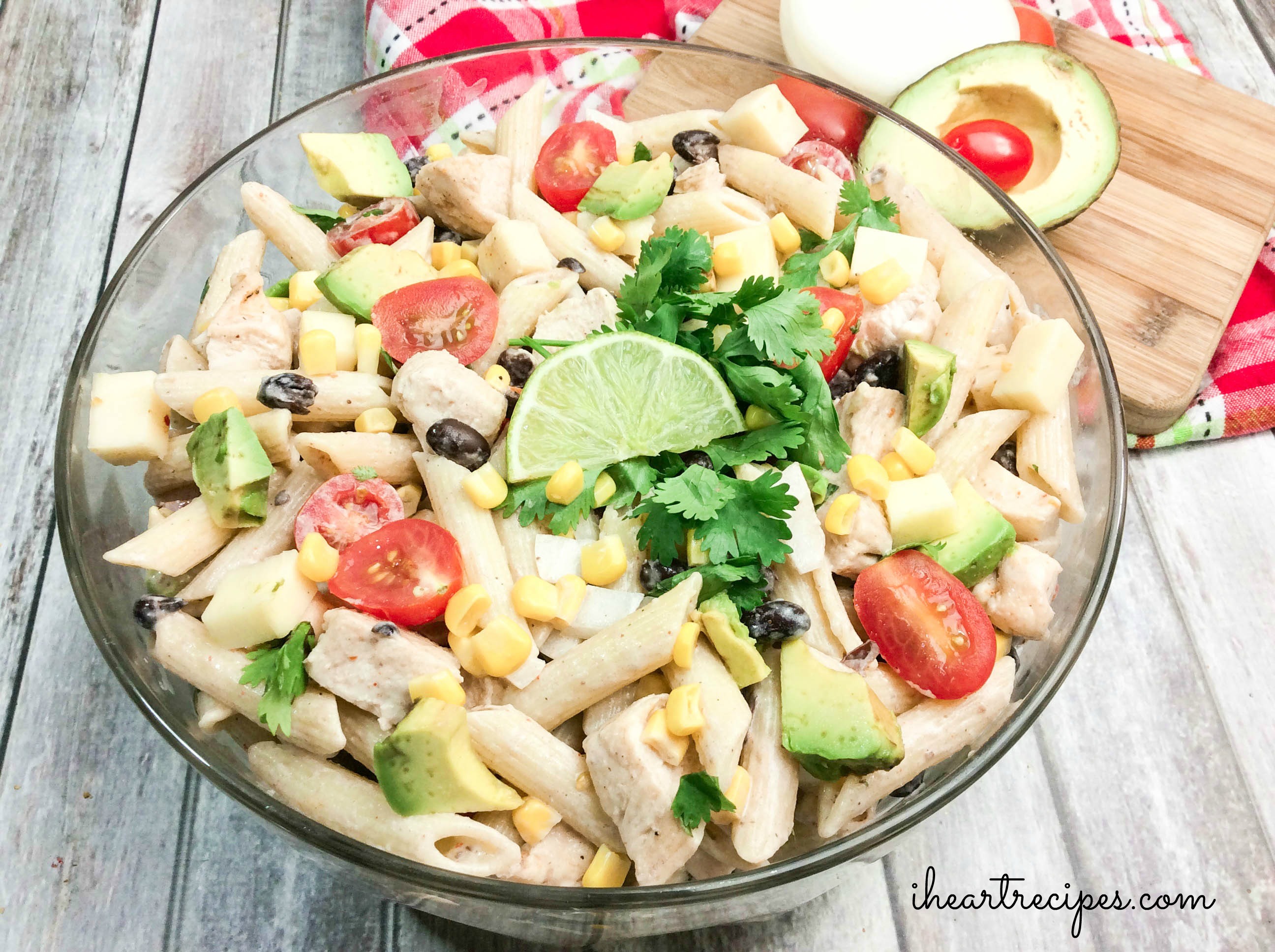 Creamy Cilantro Ranch Pasta Salad fills a classic glass serving bowl. This salad is bursting with color and flavor!