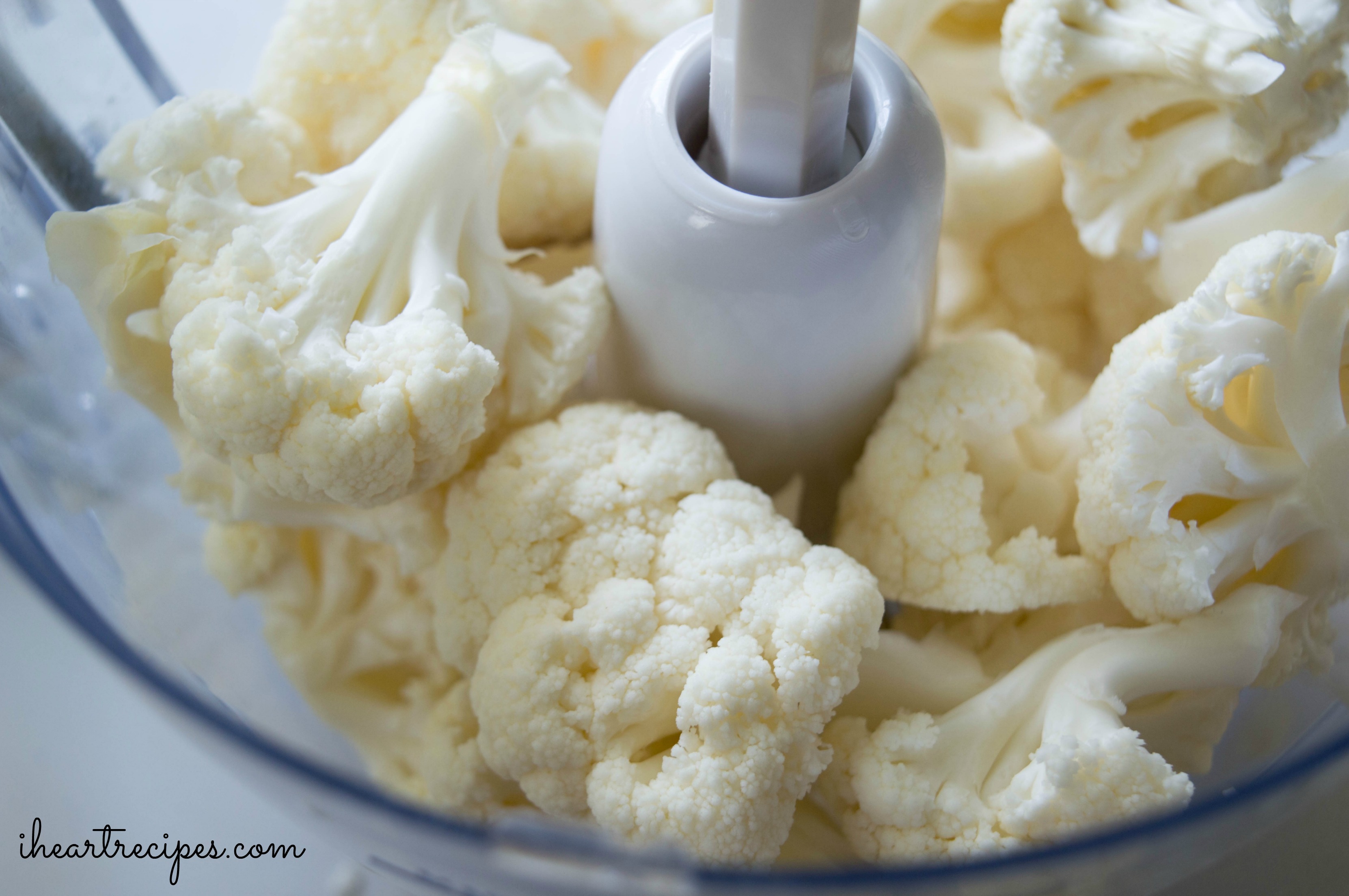 To make riced cauliflower, add a head of rice into a food processor.