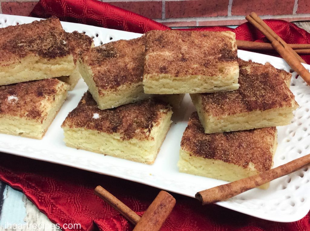 Sweet and Chewy Snickerdoodles Bars, piled on top of a lacy white platter, ready to be served!