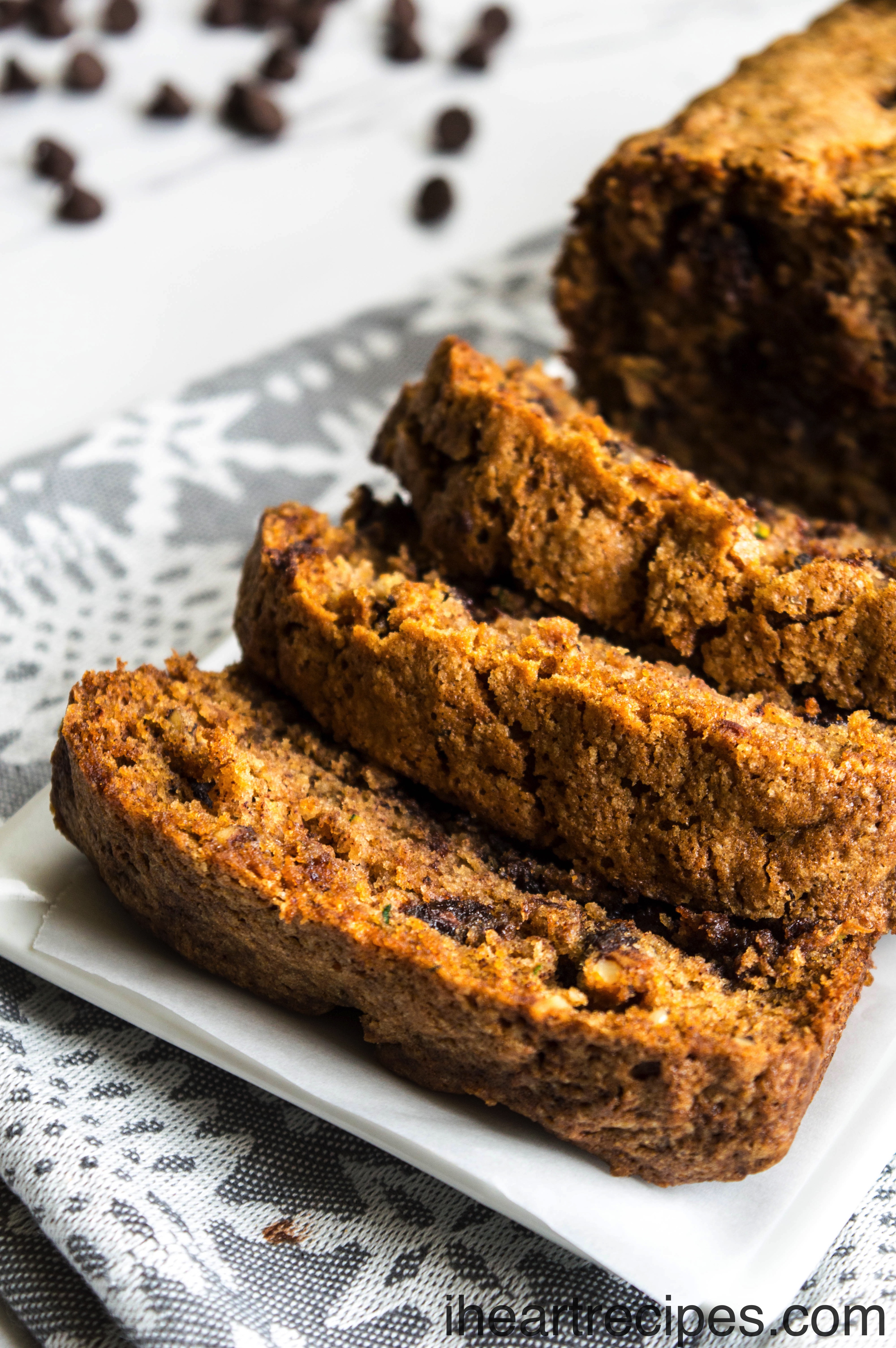 Tender zucchini bread with gooey chocolate chips served on a white platter. It's a simple, sweet dessert.