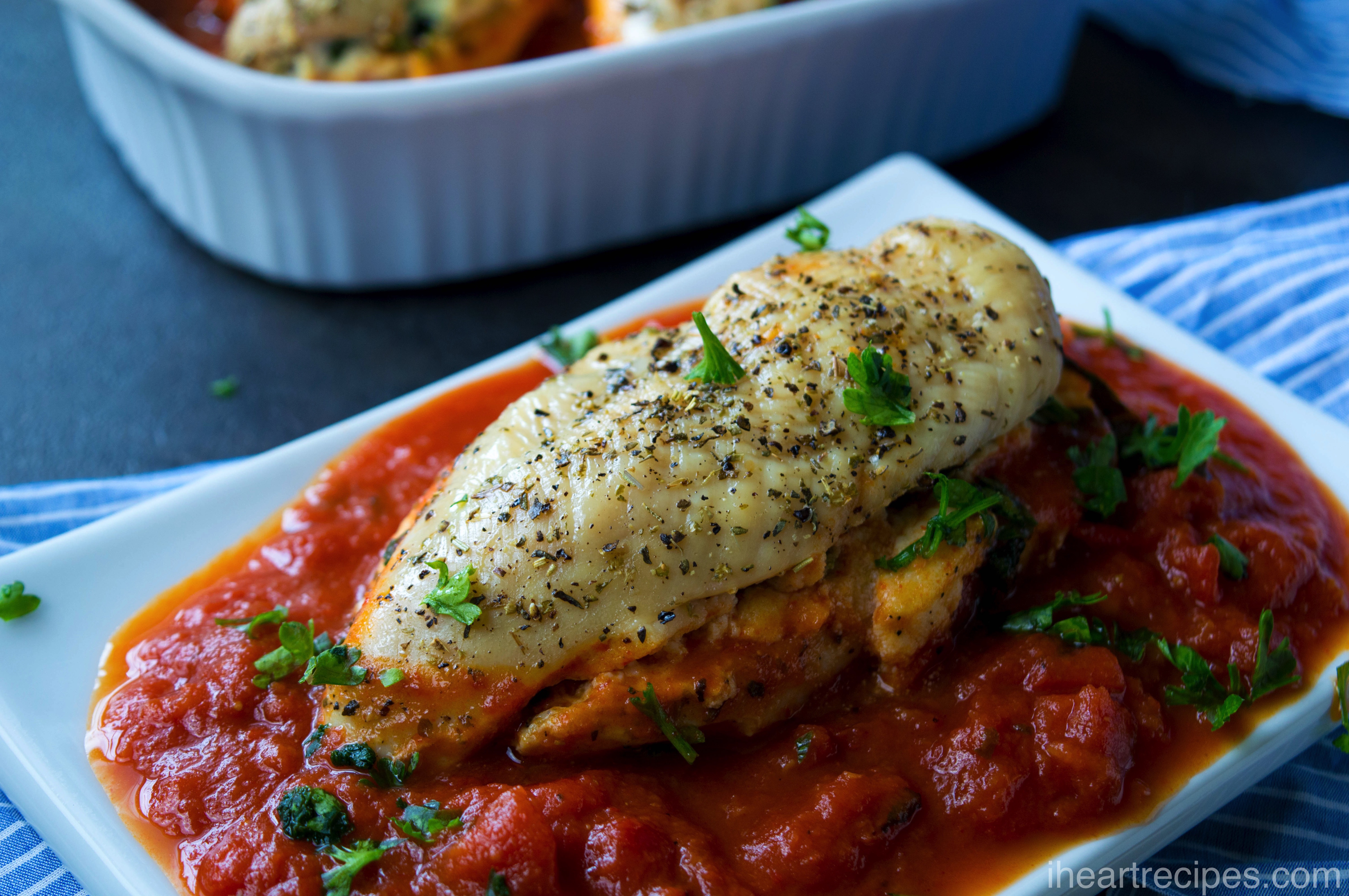 This stuffed chicken breast recipe is made with spinach and ricotta cheese and topped with marinara and italian herbs