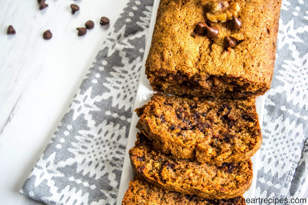 A loaf of moist Chocolate Zucchini Bread served on a long rectangular white platter. 