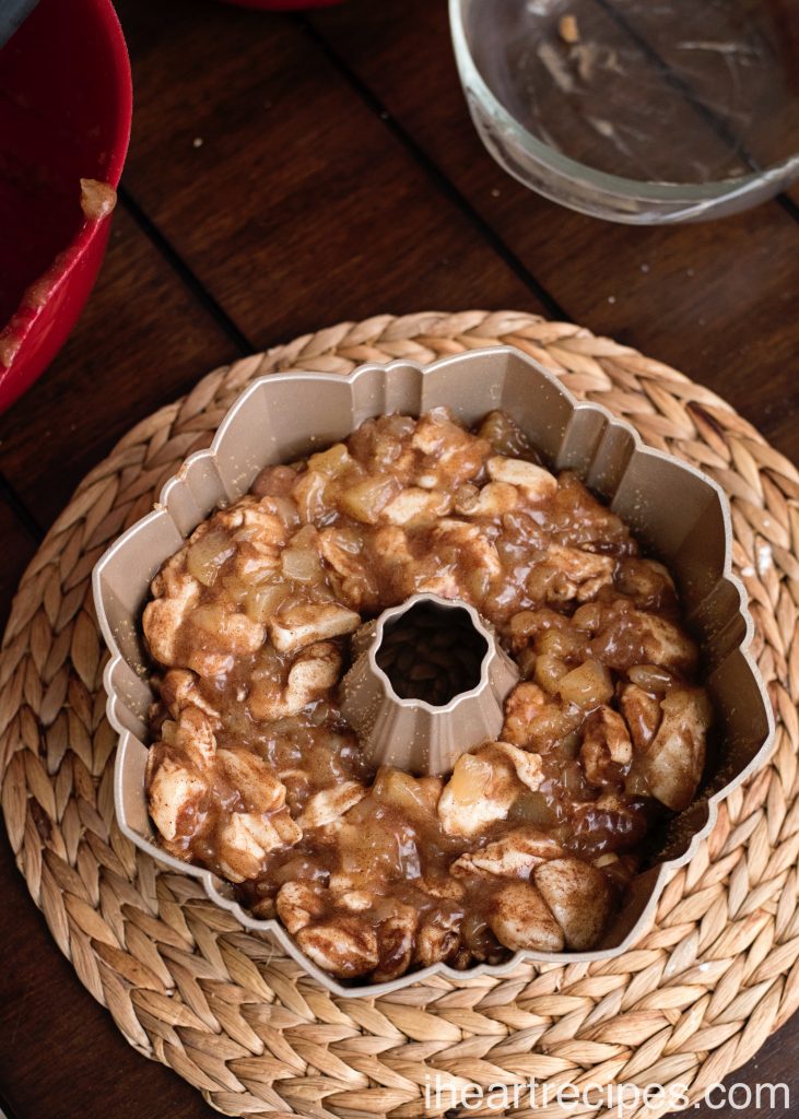 Cinnamon Apple Monkey Bread in a decorative bundt pan ready to be baked. 