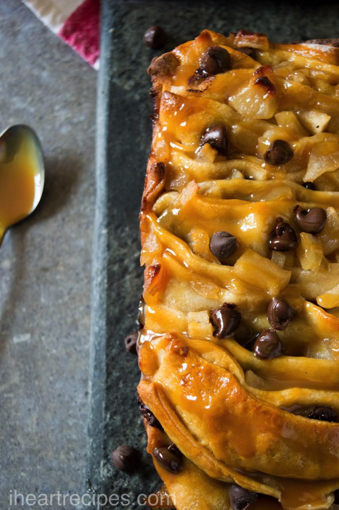 Tender layers of dough filled with tart apples and sweet chocolate chips placed on a grey stone platter ready to be served! 