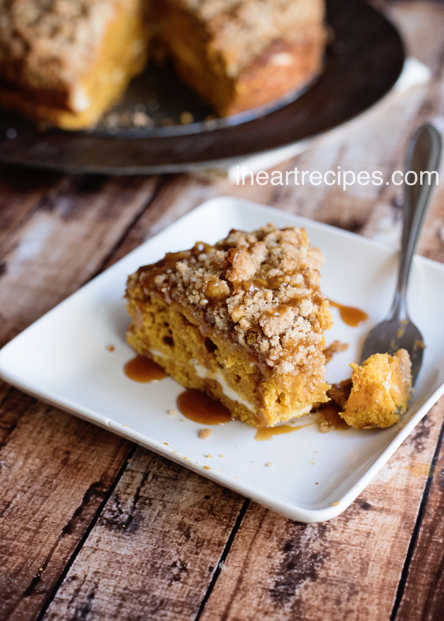 This slice of caramel coffee cake has a fluffy cream cheese filling and is drizzled with a sweet caramel syrup.