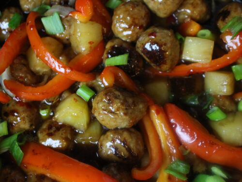 Meatballs with sweet & sour sauce, pineapple chunks, onions, and sweet red peppers.