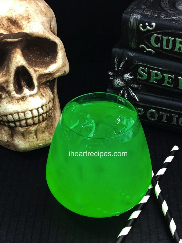 This vibrant green Embalming Fluid Cocktail sits in perfect company with the spooky decorations!