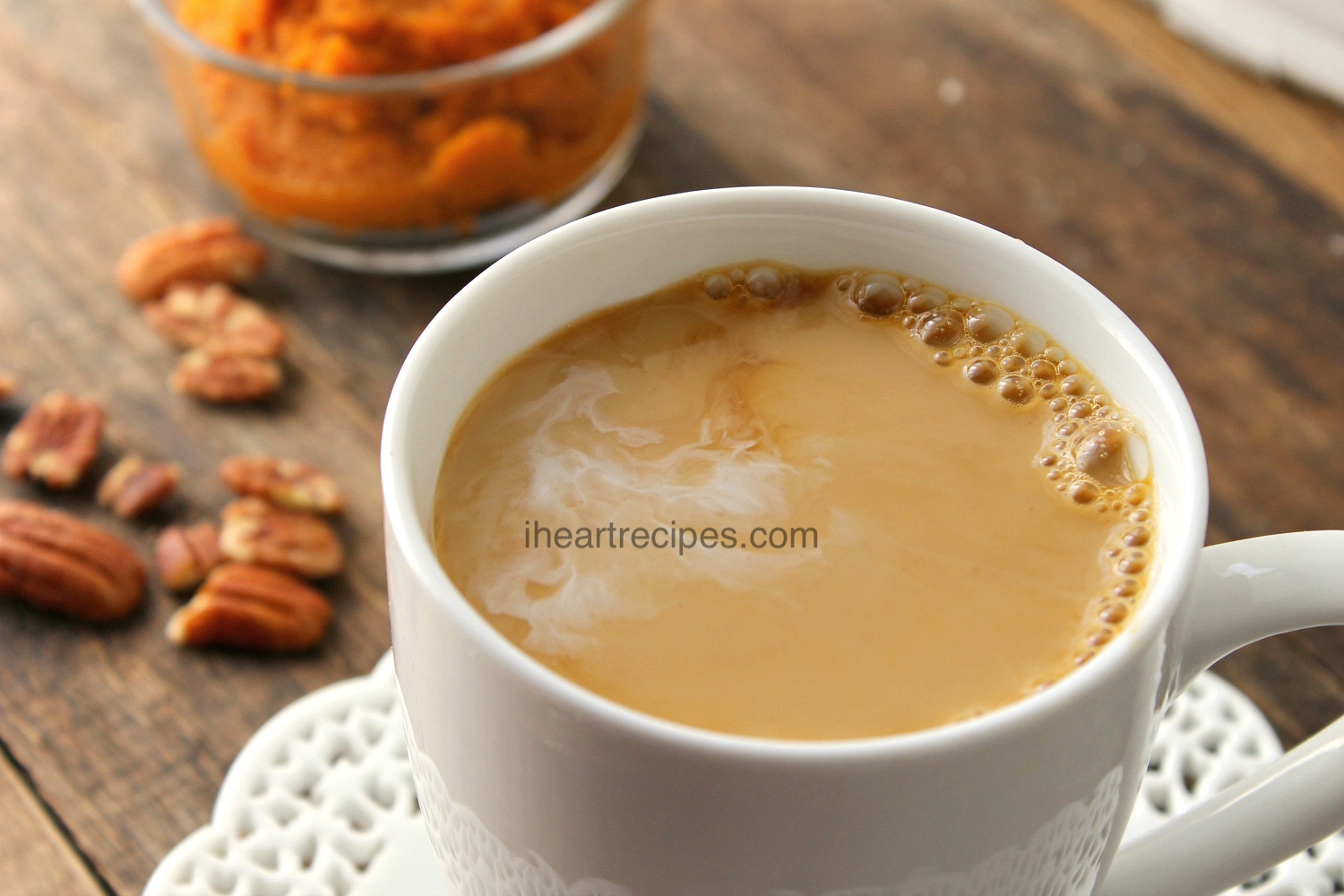 A piping hot pumpkin spice latte served in a classic white mug to be enjoyed in the comforts of your own home!