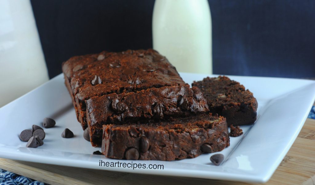 Thick slices of moist chocolate banana bread served on a square white plate garnished with chocolate chips. This recipe is made with rich cocoa powder and chocolate chips.