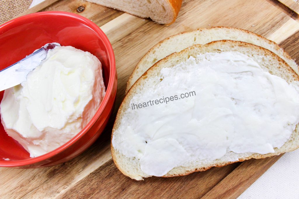 Creamy homemade butter spread over a soft, fresh slice of white bread.