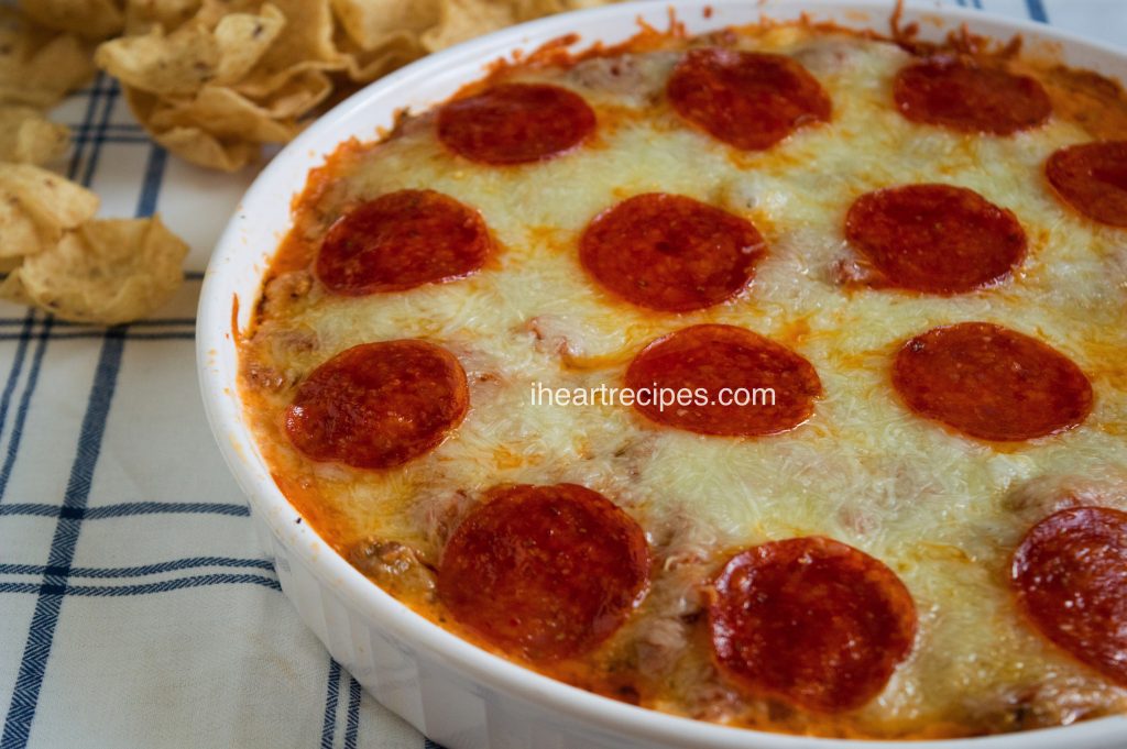 Baked Pepperoni & Sausage Pizza Dip is a creamy and cheesy appetizer your guests will love!