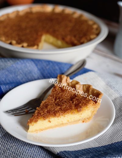 A single slice of homemade old-fashioned chess pie served on a white plate.
