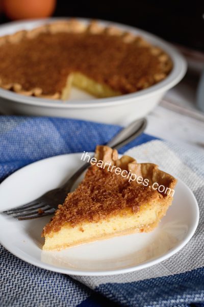 A single slice of homemade old-fashioned chess pie served on a white plate.