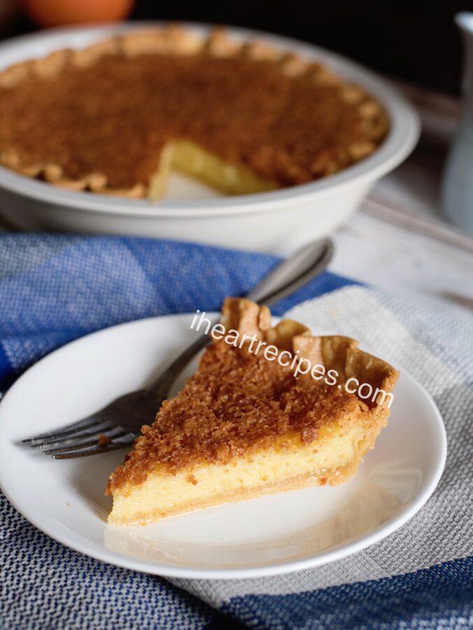 A single slice of homemade old-fashioned chess pie served on a white plate.